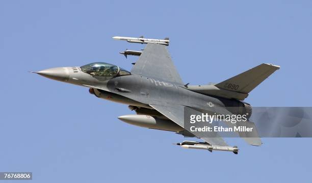 An F-16C Fighting Falcon flies by during a U.S. Air Force firepower demonstration at the Nevada Test and Training Range September 14, 2007 near...