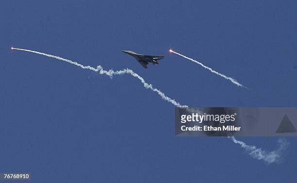 Lancer drops a flare as it flies by a flare dropped by another B-1B during a U.S. Air Force firepower demonstration at the Nevada Test and Training...