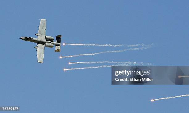 An A-10 Thunderbolt drops flares during a U.S. Air Force firepower demonstration at the Nevada Test and Training Range September 14, 2007 near Indian...