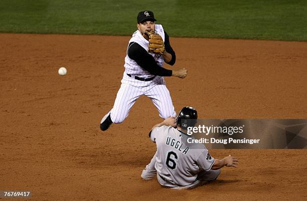 Second baseman Jamey Carroll of the Colorado Rockies gets a force on Dan Uggla of the Florida Marlins at second base but was unable to complete the...