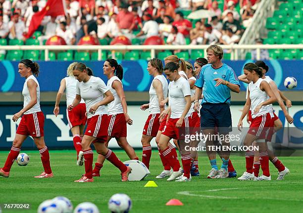 Denmark's assistant coach Nielsen Per gives instructions to his players before their 2007 FIFA Women's World Cup Football match tournament Group D at...