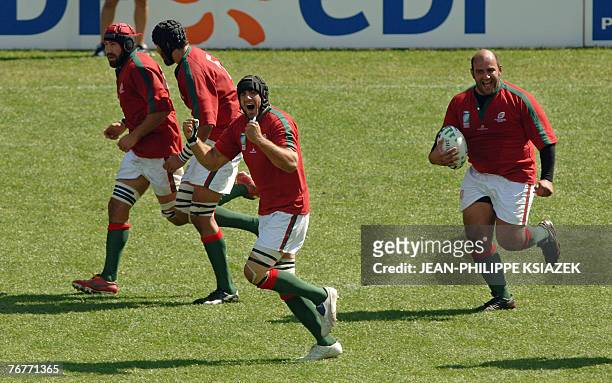 Portugal's prop Rui Cordeiro reacts after scoring a try as teammates celebrate during their rugby union World Cup group C match New-Zealand vs....