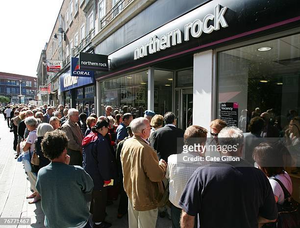 Customers of Northern Rock queue outside the Kingston branch of the company on Castle Street, in order to take their money out of their accounts on...