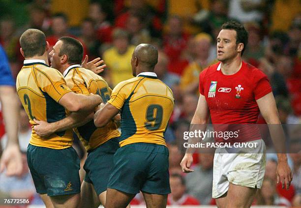 Australia's fullback Chris Latham is congratulated by team-mates hooker Stephen Moore and scrum-half George Gregan during the rugby union World Cup...