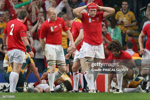 Wales's lock Alun-Wyn Jones reacts next to Wales's flanker Martyn Williams , Wales's hooker Matthew Rees and Wales's flanker Colin Charvis during the...