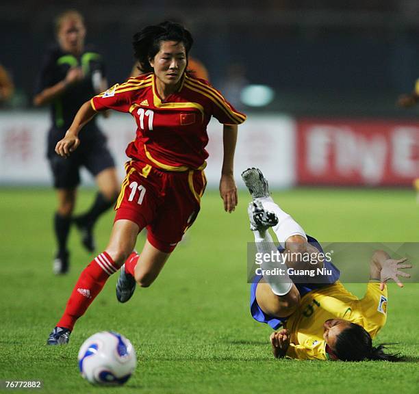 Marta of Brazil and Pu Wei of China fight for a ball during the Group D Womens World Cup match at Wuhan Sports Center Stadium September 15, 2007 in...