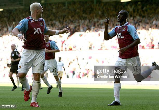Dean Ashton of West Ham United celebrates with teammate Carlton Cole during the Barclays Premier League match between West Ham United and...