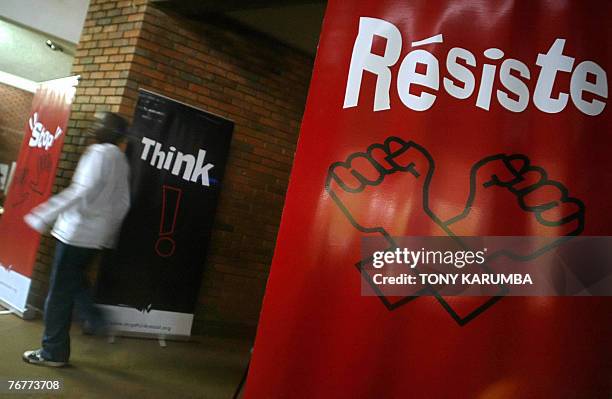 Man walks past banners against the EU backed Economic Partnership Agreements EPA's September 2007, at a concert by Kenyan artists aimed at creating...