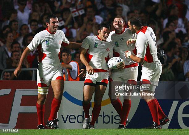 Giorgi Shkinin of Georgia is congratulated by his team mates after scoring his team's first try during Match Sixteen of the Rugby World Cup 2007...