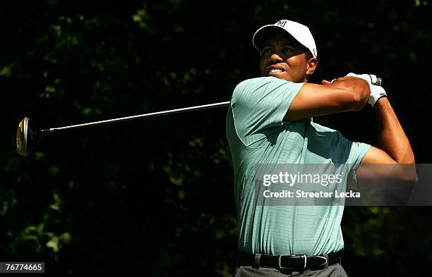 Tiger Woods watches his tee shot on the 3rd hole during the third round of the TOUR Championship, the final event of the new PGA TOUR Playoffs for...