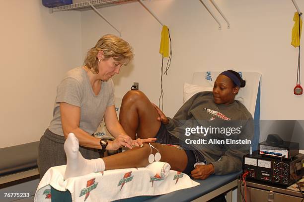 Cheryl Ford of the Detroit Shock receives treatment from Shock trainer Laura Ramus after practice the day before Game Five of the 2007 WNBA Finals on...