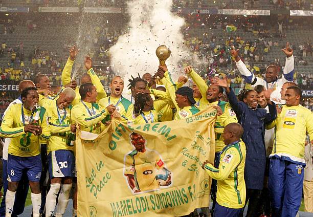 the mamelodi sundowns players pose with the trophy after winning the final during the saa supa