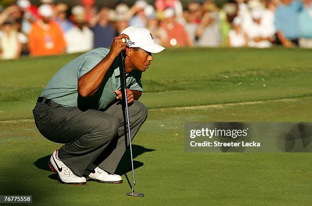Tiger Woods lines up a putt on the 18th hole during the third round of the TOUR Championship, the final event of the new PGA TOUR Playoffs for the...