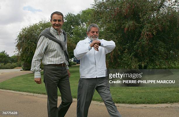 Spanish Prime Minister Jose Luis Rodriguez Zapatero walks with Brazilian President Luiz Inacio Lula da Silva at the Quintos de Mora ranch near...