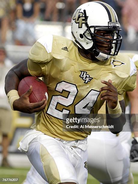 Running back Kevin Smith of the University of Central Florida Knights rushes upfield against the Texas Longhorns at Bright House Networks Stadium on...