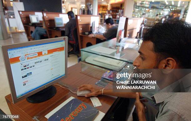 Internet surfers sit and use computers at a shopping mall in Colombo 15 September 2007. Home to some 1.5 billion people, South Asia is paying a high...