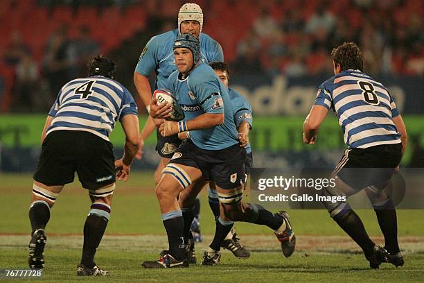 Francois van der Merwe and Robbie Diack about to tackle Francios van Schouwenburg during the Absa Currie Cup match between Blue Bulls and Western...
