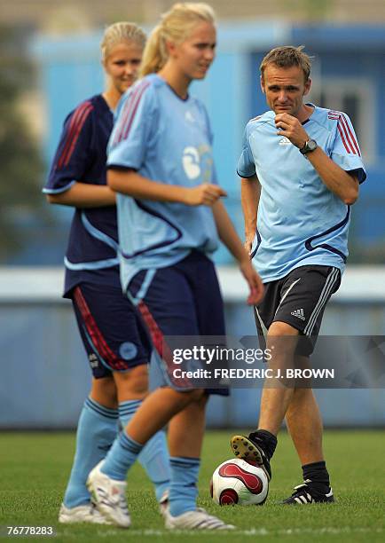 Denmark's coach Kenneth Heiner-Moller and players at a training session in Hangzhou, 16 September 2007, in eastern China's Zhejiang province, ahead...