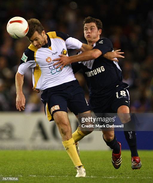 Damien Brown of the Mariners heads the ball clear of Leigh Broxham of the Victory during the round four A-League match between the Melbourne Victory...