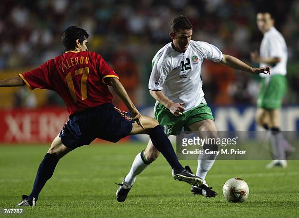 Mark Kinsella of the Republic of Ireland takes the ball past Juan Carlos Valeron of Spain during the FIFA World Cup Finals 2002 Second Round match...
