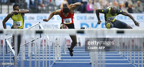 David Payne, Ryan Wilson and Allen Johnson, all of the US compete in the men's 110m hurdles event during the ISTAF Golden League athletics meeting in...