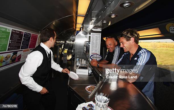 Gilbert Enoka and Andrew Ellis of the New Zealand All Blacks order a coffee on the TGV high speed train on September 16, 2007 as the team travels...