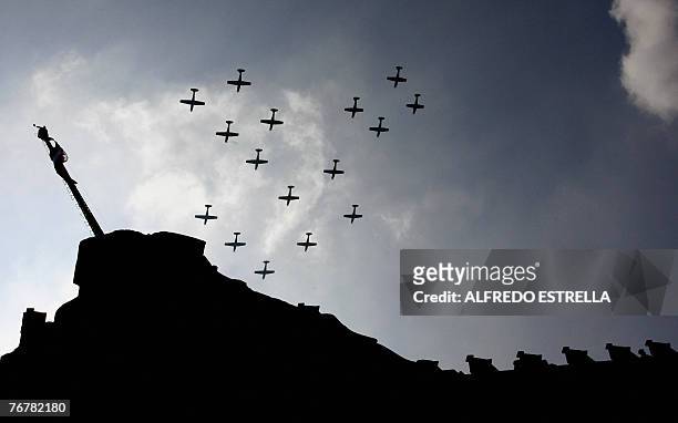 Airplanes of the Mexican Air Force fly over the National Palace at the Zocalo Square in Mexico City, during a military parade marking the 197th...