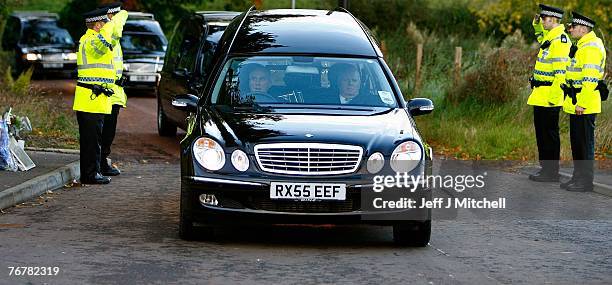 Four coffins from Saturday's helicopter crash near Lanark are taken away from the scene in hearses September 16, 2007 in Lanark, Scotland. The former...