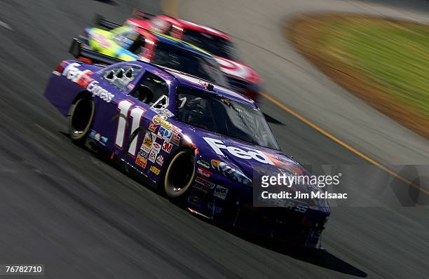 Denny Hamlin, driver of the FedEx Express Chevrolet, races during the NASCAR Nextel Cup Series Sylvania 300 at New Hampshire International Speedway...