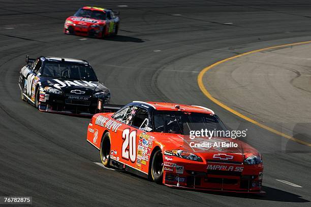 Tony Stewart, driver of the The Home Depot Chevrolet, leads Clint Bowyer, driver of the Jack Daniel's Chevrolet, and Jeff Gordon, driver of the...