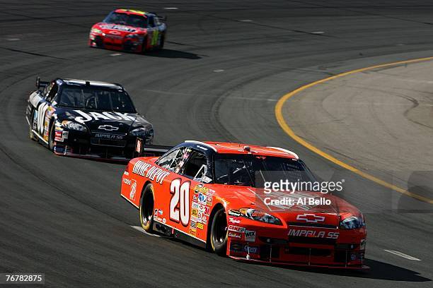 Tony Stewart, driver of the The Home Depot Chevrolet, leads Clint Bowyer, driver of the Jack Daniel's Chevrolet, and Jeff Gordon, driver of the...