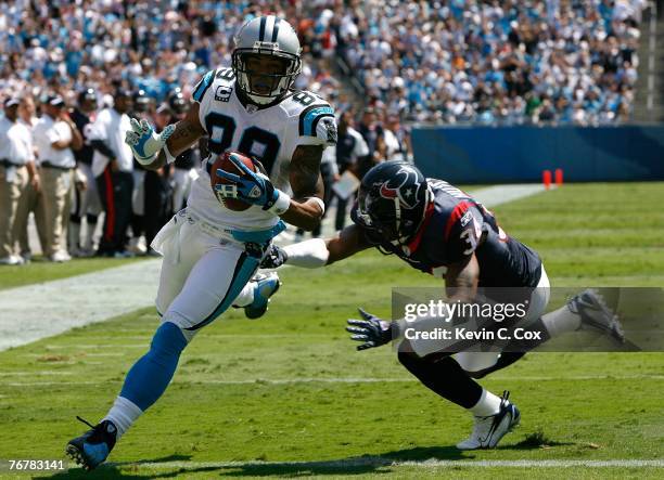 Receiver Steve Smith of the Carolina Panthers scores a touchdown past free safety Von Hutchins of the Houston Texans during the Texans 34-21 win at...