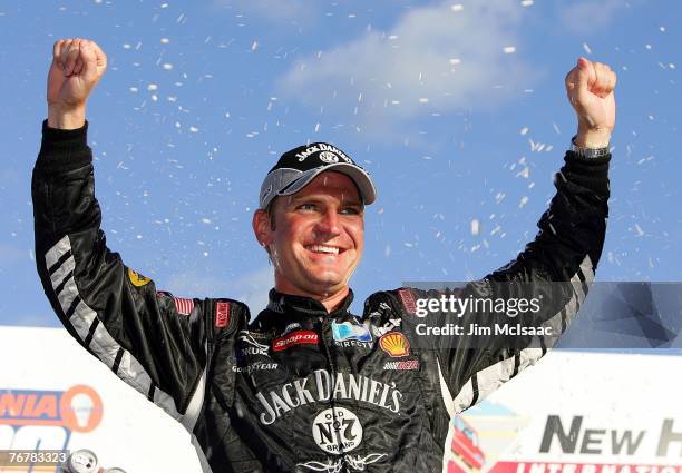 Clint Bowyer, driver of the Jack Daniel's Chevrolet, celebrates with teammates after winning the NASCAR Nextel Cup Series Sylvania 300 at New...