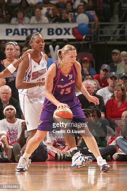 Penny Taylor of the Phoenix Mercury dribbles the ball against Kara Braxton of the Detroit Shock during Game Five of the WNBA Finals at The Palace of...