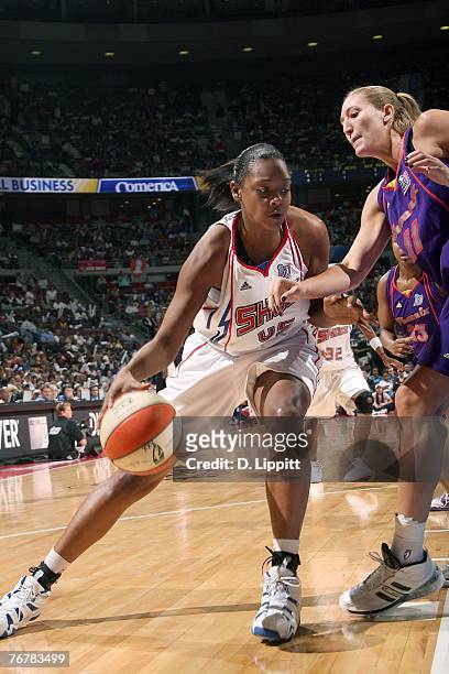 Kara Braxton of the Detroit Shock drives to the basket against Kelly Schumacher of the Phoenix Mercury during Game Five of the WNBA Finals at The...
