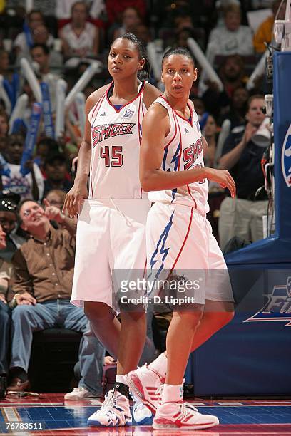 Plenette Pierson and Kara Braxton of the Detroit Shock look on during Game Five of the WNBA Finals against the Phoenix Mercury at The Palace of...