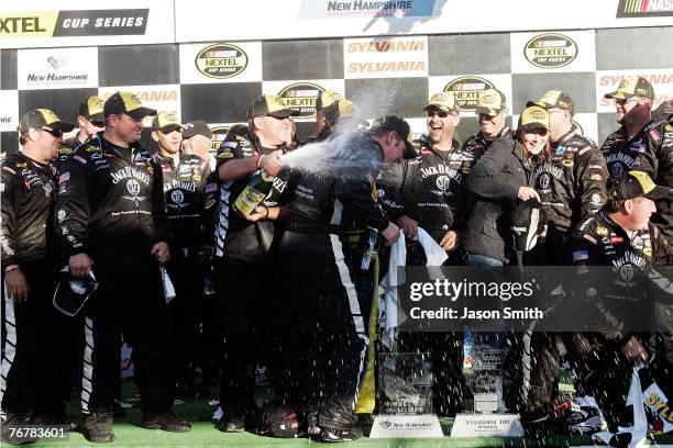Clint Bowyer, driver of the Jack Daniel's Chevrolet, celebrates with teammates after winning the NASCAR Nextel Cup Series Sylvania 300 at New...