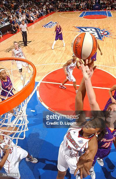 Kelly Schumacher of the Phoenix Mercury blocks the shot of Kara Braxton of the Detroit Shock during Game Five of the WNBA Finals at The Palace of...