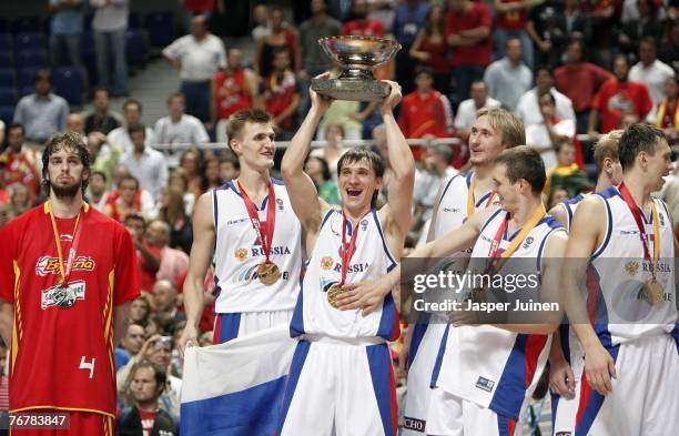 Pau Gasol of Spain stands dejected as Petr Samoylenko holds up the trophy celebrating amid his teammates after beating Spain during the FIBA...