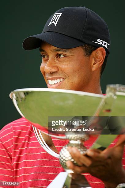 Tiger Woods holds the FedEx Cup trophy after winning the TOUR Championship, the final event of the new PGA TOUR Playoffs for the FedExCup at East...