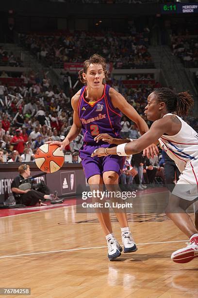 Kelly Miller of the Phoenix Mercury dribbles the ball against Shannon Johnson of the Detroit Shock during Game Five of the WNBA Finals at The Palace...