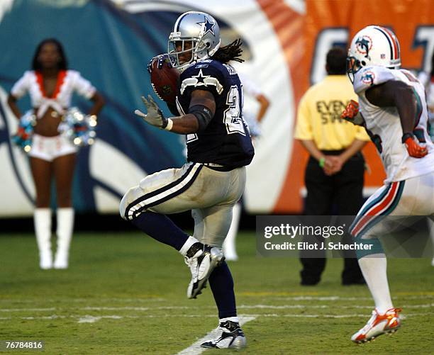 Running back Marion Barber of the Dallas Cowboys heads into the end zone for a touchdown against Safety Renaldo Hill of the Miami Dolphins in the...