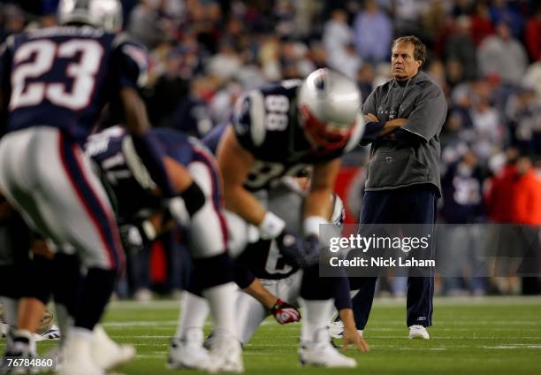 Head coach Bill Belichick of the New England Patriots watches warm-ups before their game against the San Diego Chargers at Gillette Stadium September...