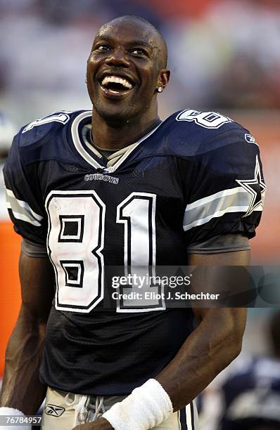 Wide receiver Terrell Owens of the Dallas Cowboys smiles while on the sidelines against the Miami Dolphins in the fourth quarter at Miami Dolphin...