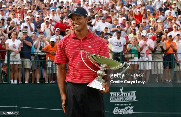 Tiger Woods holds the FedExCup trophy following the fourth round of THE TOUR Championship, the final event of the new PGA TOUR Playoffs for the...