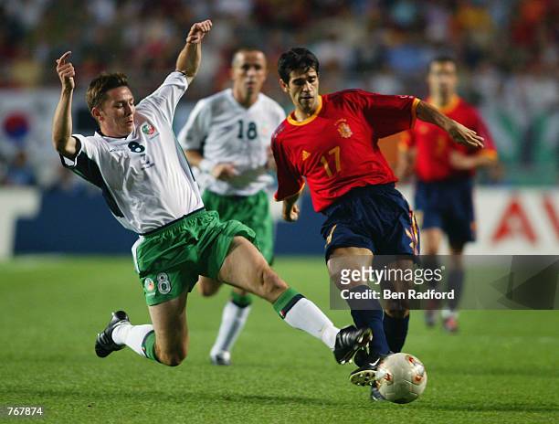 Matt Holland of the Republic of Ireland tackles Juan Carlos Valeron of Spain during the FIFA World Cup Finals 2002 Second Round match played at the...