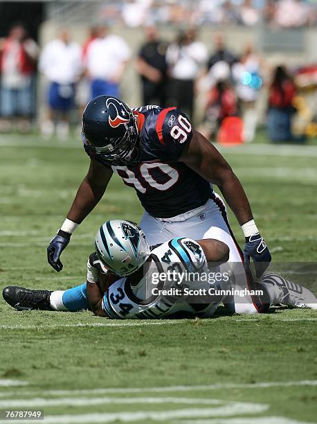 Mario Williams of the Houston Texans finishes a tackle against DeAngelo Williams of the Carolina Panthers at Bank of America Stadium September 16,...