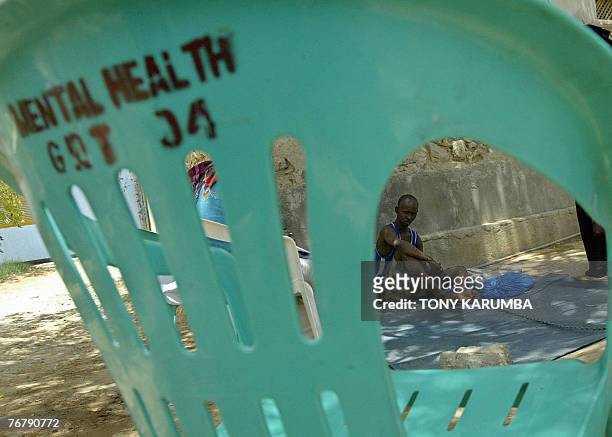Photo taken 08 September 2007 shows a psychologically-disturbed Somali man chained to a tree at the psychiatric ward of the general hospital of the...