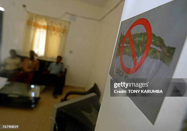 Photo taken 08 September 2007 shows Somali men at a hotel room with posters advocating giving up Khat chewing in the northern Somali port of Bosasso....