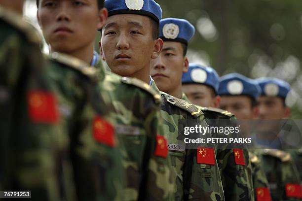 People's Liberation Army soldiers deployed for United Nations peace keeping missions line up at their base in China's central Henan province before...